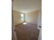 Bedroom with carpet, window, and a closet door at 4855 Coral Castle Dr, Kissimmee, FL 34746