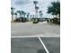 Gated community entrance with well-maintained landscaping and tall palm trees at 4855 Coral Castle Dr, Kissimmee, FL 34746