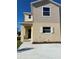 Charming two-story home featuring neutral siding, well-kept landscape, and a concrete driveway at 4855 Coral Castle Dr, Kissimmee, FL 34746