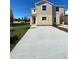 Inviting two-story home with a spacious concrete driveway and well-maintained lawn at 4855 Coral Castle Dr, Kissimmee, FL 34746