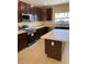 Beautiful kitchen with dark cabinetry, stainless appliances, and a functional center island at 4855 Coral Castle Dr, Kissimmee, FL 34746