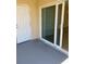 Covered patio featuring a sliding glass door and a white door at 4855 Coral Castle Dr, Kissimmee, FL 34746