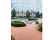 Community pool area with ample lounge chairs, manicured landscaping, and multi-story buildings at 4855 Coral Castle Dr, Kissimmee, FL 34746