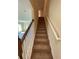 Carpeted staircase with white railing leading to the upper level at 4855 Coral Castle Dr, Kissimmee, FL 34746
