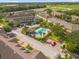 Aerial view of a community featuring lush landscaping, a sparkling pool and well-maintained townhomes at 4981 Alita Ter, St Cloud, FL 34769