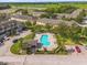 Aerial view of a community featuring a pool, palm trees, and vibrant landscaping at 4981 Alita Ter, St Cloud, FL 34769