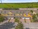 An aerial view showcases a community of townhomes with garages and verdant green spaces at 4981 Alita Ter, St Cloud, FL 34769