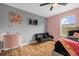 Stylish bedroom featuring wood floors, a ceiling fan and a cozy seating area at 4981 Alita Ter, St Cloud, FL 34769