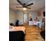 Bright bedroom featuring wood-look floors, a ceiling fan, and a vanity area, creating a cozy atmosphere at 4981 Alita Ter, St Cloud, FL 34769