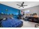 A roomy bedroom with a workstation, ceiling fan and a bed at 4981 Alita Ter, St Cloud, FL 34769