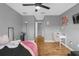 A bedroom featuring hardwood floors, a ceiling fan, and a cozy workspace with a desk at 4981 Alita Ter, St Cloud, FL 34769
