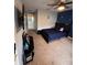 Bedroom with blue accent wall, ceiling fan, carpet, TV, and a black bed at 4981 Alita Ter, St Cloud, FL 34769
