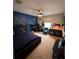 Bedroom with a carpet floor, ceiling fan, blue accent wall, desk, and a fish tank at 4981 Alita Ter, St Cloud, FL 34769