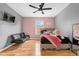 A well-lit bedroom features hardwood floors, black futon and a window at 4981 Alita Ter, St Cloud, FL 34769