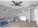 Bright ' room features a ceiling fan, crib and changing table at 4981 Alita Ter, St Cloud, FL 34769