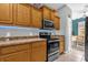 A well-lit kitchen features wooden cabinets, stainless steel appliances, and tile floors at 4981 Alita Ter, St Cloud, FL 34769