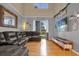 Cozy living room with vaulted ceiling, hardwood floors and oversized couch at 4981 Alita Ter, St Cloud, FL 34769
