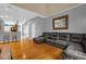 Open concept living room with hardwood floors, mirror and grey sectional at 4981 Alita Ter, St Cloud, FL 34769