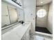 Contemporary bathroom featuring marble-look tile, a sleek vanity, and a walk-in shower with unique round window at 5017 Laguna Bay Cir # 96, Kissimmee, FL 34746