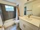 Clean bathroom featuring gray tile, a white vanity with storage, and a shower-tub combo with curtain at 5017 Laguna Bay Cir # 96, Kissimmee, FL 34746