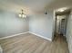 Bright dining room with wood-look flooring, a modern chandelier, and a neutral color palette at 5017 Laguna Bay Cir # 96, Kissimmee, FL 34746