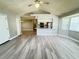 Bright and spacious living area with new wood-look flooring, a ceiling fan, and open access to the kitchen at 5017 Laguna Bay Cir # 96, Kissimmee, FL 34746