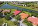 Aerial view of homes near the lake boasting mature trees and terracotta roofs at 517 Milano Rd, Poinciana, FL 34759