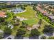 Golf course community featuring lush landscaping, a water feature and well-maintained homes at 517 Milano Rd, Poinciana, FL 34759