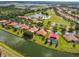 Stunning aerial view of a villa, showcasing the tiled roof, landscaping, and canal front location at 517 Milano Rd, Poinciana, FL 34759