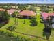 Overhead view of home and backyard with pond, mature landscaping, and screen enclosure at 517 Milano Rd, Poinciana, FL 34759