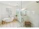 Beautiful bathroom features a glass-enclosed shower, soaking tub, and tile flooring at 517 Milano Rd, Poinciana, FL 34759