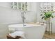 Close-up of a soaking tub in a bright bathroom with a modern faucet and decor at 517 Milano Rd, Poinciana, FL 34759