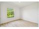 Bright bedroom with a large window view of the lake and trees offering natural light at 517 Milano Rd, Poinciana, FL 34759
