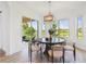 Dining room with backyard view, natural lighting, modern light fixture, and sliding door at 517 Milano Rd, Poinciana, FL 34759