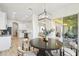 Bright dining area next to a modern kitchen and an outdoor living space at 517 Milano Rd, Poinciana, FL 34759