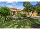 Inviting home with a barrel tile roof, lush landscaping, and brick paver walkway at 517 Milano Rd, Poinciana, FL 34759
