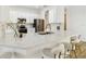 Modern kitchen with stone countertop island, stainless steel appliances, and white cabinets at 517 Milano Rd, Poinciana, FL 34759