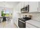 Bright kitchen with white cabinets, stainless appliances and a dining area with backyard views at 517 Milano Rd, Poinciana, FL 34759