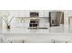 Modern kitchen with stone countertop island, stainless steel appliances, and white cabinets at 517 Milano Rd, Poinciana, FL 34759