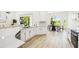 Bright kitchen with white cabinets, stainless appliances, and a dining area with views of the backyard at 517 Milano Rd, Poinciana, FL 34759