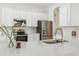 Bright kitchen features white cabinets, stainless steel appliances, stone countertops and tile backsplash at 517 Milano Rd, Poinciana, FL 34759