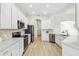 Spacious kitchen with stainless steel appliances, stone countertops, and white cabinets at 517 Milano Rd, Poinciana, FL 34759
