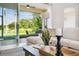 Cozy living space with comfortable seating and a view of the serene outdoor scenery at 517 Milano Rd, Poinciana, FL 34759
