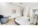 Spacious main bedroom with white trim, a tray ceiling, and a patterned armchair at 517 Milano Rd, Poinciana, FL 34759