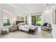 Main bedroom with tray ceilings, accent wall art, and a sliding door to the patio at 517 Milano Rd, Poinciana, FL 34759