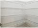 Walk-in pantry with white metal shelving and ample storage space at 517 Milano Rd, Poinciana, FL 34759