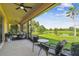 Screened lanai with ceiling fan overlooking beautiful lake views at 517 Milano Rd, Poinciana, FL 34759