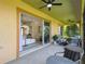 Covered patio with living area views and access to the backyard at 517 Milano Rd, Poinciana, FL 34759