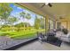 Screened-in patio with fire pit and relaxing seating overlooking the lake at 517 Milano Rd, Poinciana, FL 34759