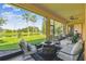 Screened-in patio with comfortable seating and gorgeous lake views at 517 Milano Rd, Poinciana, FL 34759